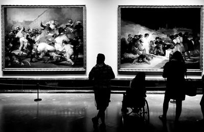 Rear view of people standing in museum