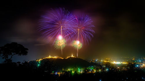 Low angle view of firework display at night