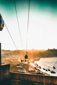 Overhead cable car over sea against sky