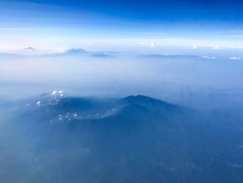 Scenic view of sea and mountains against sky