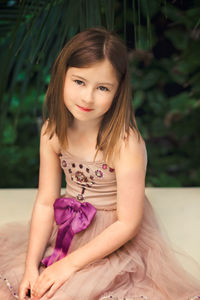 Portrait of a girl sitting outdoors