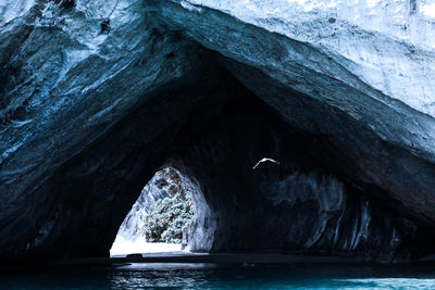 Scenic view of sea seen through cave