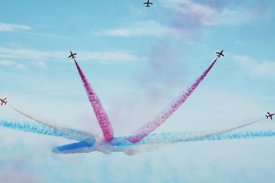 Low angle view of airplane flying against sky