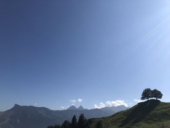Scenic view of mountains against clear blue sky