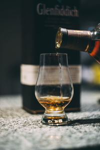 Close-up of beer glass on table