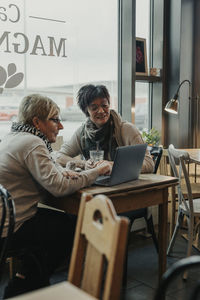 Women using laptop in cafe