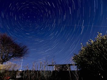 Low angle view of star field against blue sky