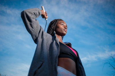 Low angle view of woman against sky