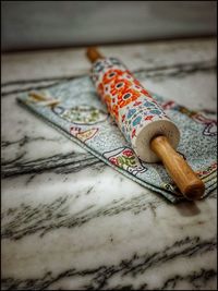 Close-up of multi colored rolling pin on floor