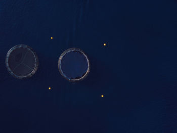 Low angle view of illuminated lights against blue sky