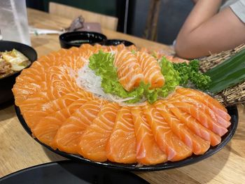 Cropped hand of woman holding sushi