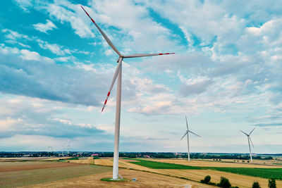 Windmill on field against sky