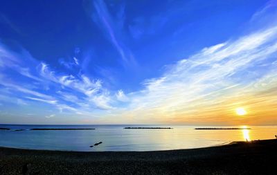 Scenic view of sea against sunset sky