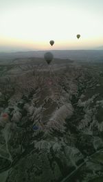 Hot air balloon flying over landscape