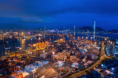 High angle view of city lit up at night