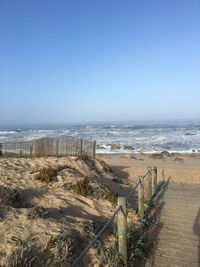 Scenic view of beach against clear sky