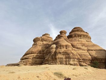 Low angle view of rock formations against sky