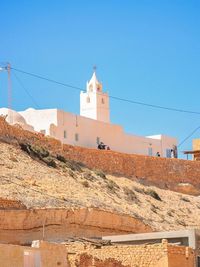 Scenic view of beach against clear blue sky