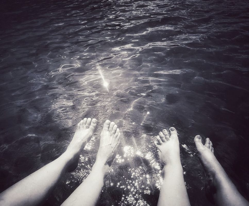 water, human leg, low section, barefoot, sea, personal perspective, human foot, black, nature, lifestyles, leisure activity, black and white, women, adult, limb, holiday, human limb, monochrome photography, one person, high angle view, trip, vacation, sunlight, day, darkness, relaxation, wave, outdoors, monochrome, white, swimming, ocean, rippled, summer, motion