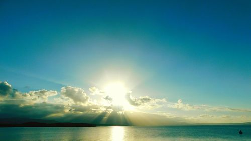 Sunlight streaming through sea against sky