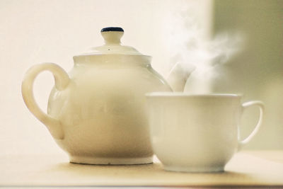 Close-up of coffee cup over white background