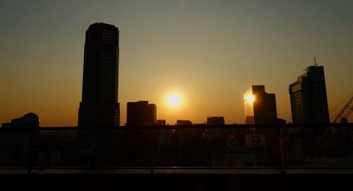 Low angle view of cityscape against sky during sunset