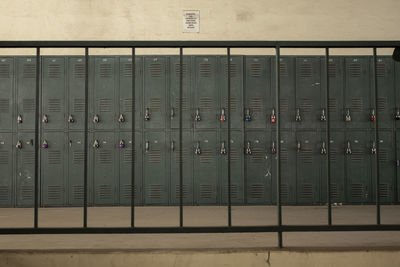 Lockers seen through railing against wall