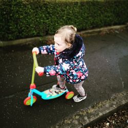 High angle view of girl playing with toy