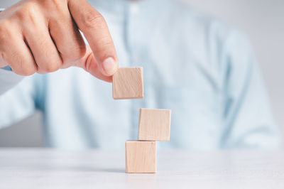 Close-up of hand holding toy on table