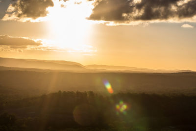 Scenic view of sunset over land