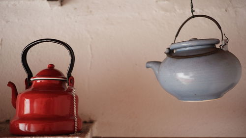 Close-up of lantern on table against wall