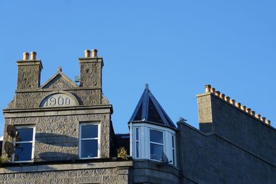 Low angle view of building against clear blue sky