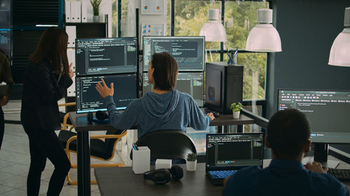 Rear view of man working in office