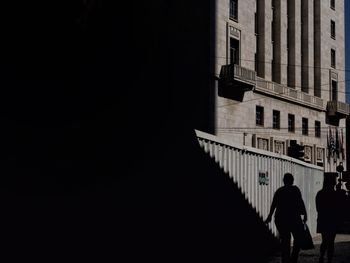 People walking in front of built structure