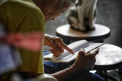 Close-up of senior woman reading book