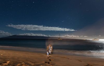 Scenic view of sea against sky at night