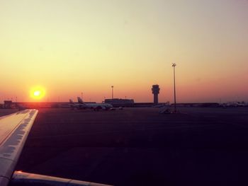 Cars on road at sunset