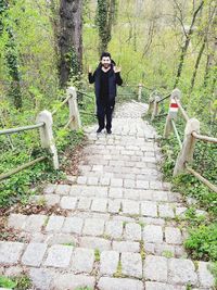 Full length of young man standing in forest