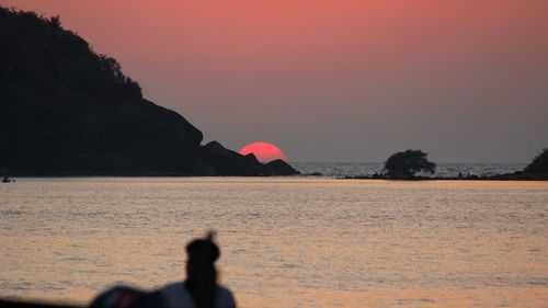 Scenic view of sea against clear sky at sunset