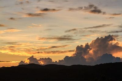 Scenic view of silhouette mountains against sky during sunset