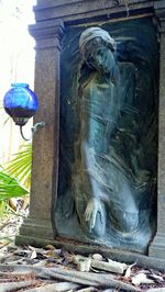 Close-up of buddha statue against building