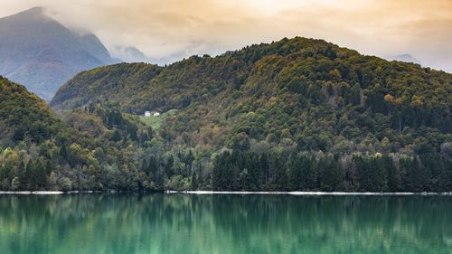 Scenic view of lake and mountains against sky