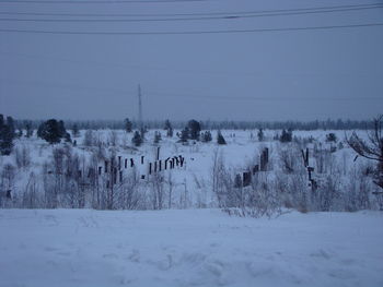 Scenic view of snow covered field against sky