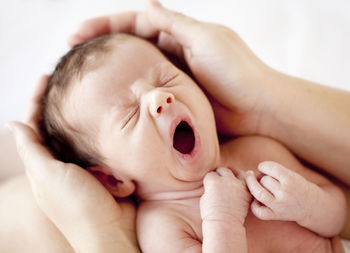 Hands holding newborn baby