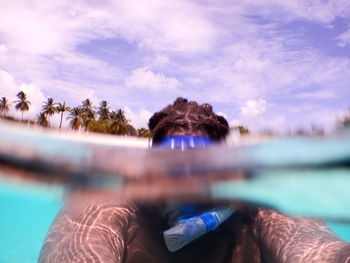 Man snorkeling in sea against sky