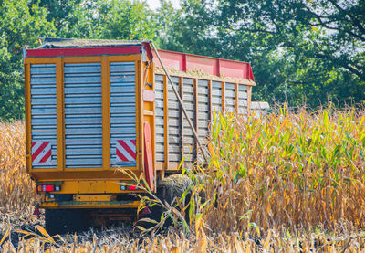 Truck parked by plants on field