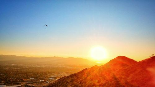 Scenic view of mountains against clear sky during sunset