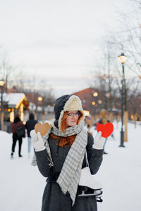 Rear view of woman wearing warm clothing while standing in winter