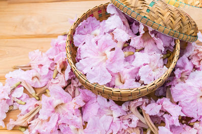 High angle view of pink flowers in basket on table