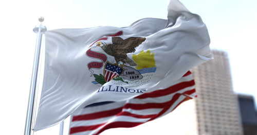 Low angle view of flags hanging on white background